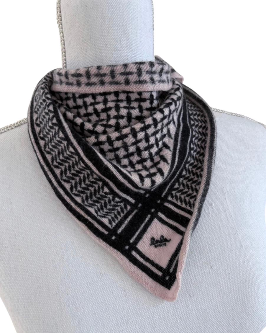Black and pink patterned scarf on a mannequin with a white background
